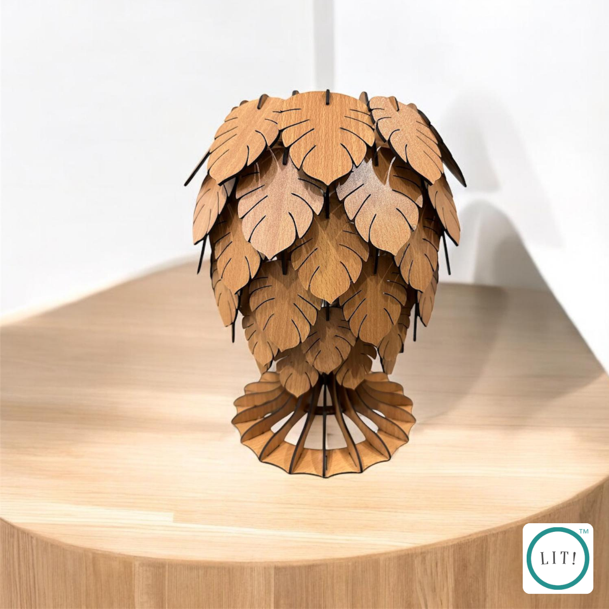 Wooden table lamp with carved monstera leaf design